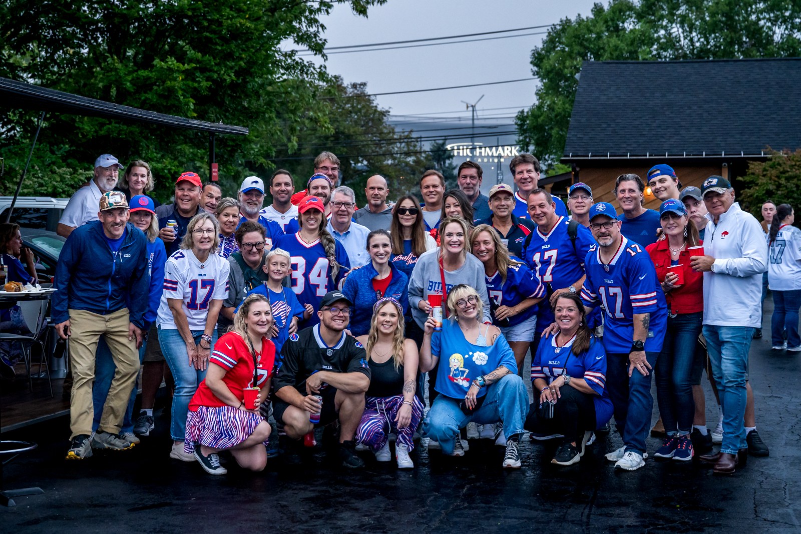 Bills fans in red and blue gathered beside their tailgate structure.